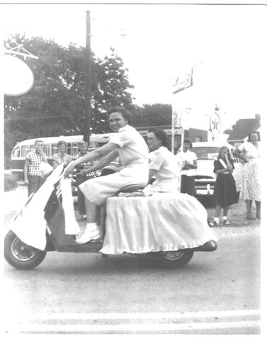 Myra Hunter and Evelyn Bean, waitresses at the Annandale Grill, join the Annansdale Parade with their decorated motorcycle - 1950's